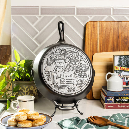 Decorative cast iron skillet with 'Georgia' design on a kitchen counter.