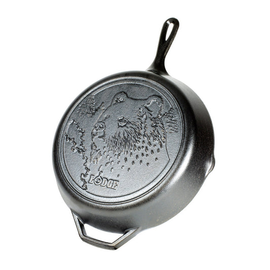 Cast iron skillet with bear design and 'Lodge' branding.