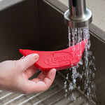 Silicone assist handle being rinsed off in sink.