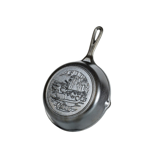 An engraved duck swimming in pond on back of cast iron skillet.