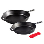 Two black cast iron skillets with a red handle holder on a white background