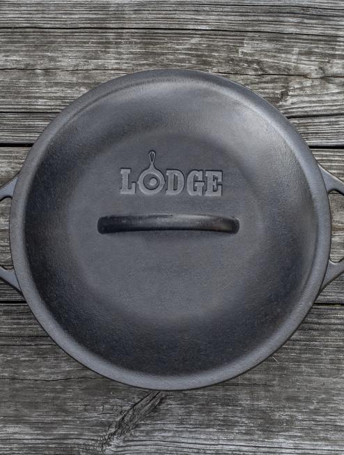 Top view of dutch oven with lid, featuring Lodge branding and lid handle.