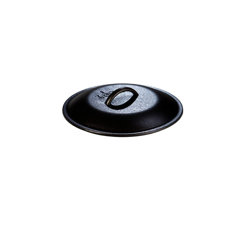 Seasoned cast iron lid with Lodge branding and handle in the middle.