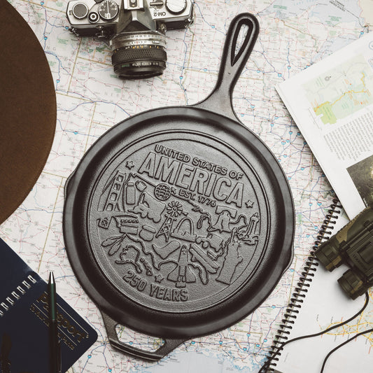 Cast iron skillet with 'United States of America' engraving on a map background.
