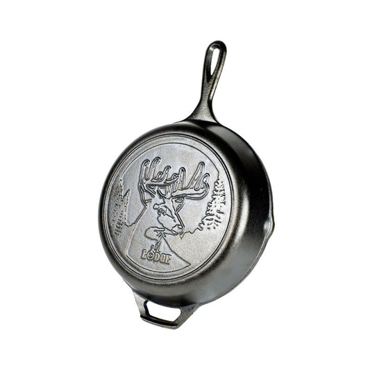 Cast iron skillet with embossed design featuring a deer with antlers in a forest.