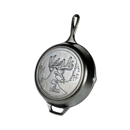 Cast iron skillet with embossed design featuring a deer with antlers in a forest.