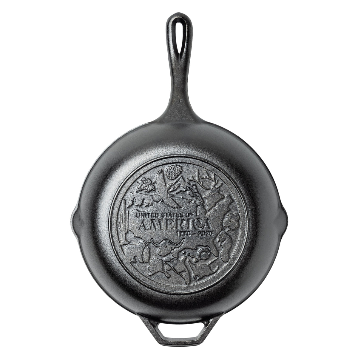 Black cast iron skillet with 'United States of America' engraving on bottom surround by images of nature and wildlife.