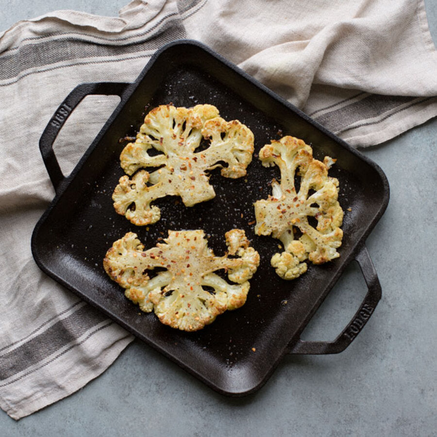 Cooked cauliflower on griddle.