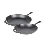 Two cast iron skillets on a white background