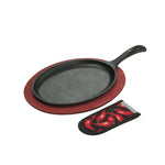 Black cast iron skillet on a red wood underling with a handle holder featuring red chili peppers on a white background