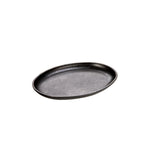 An oval-shaped, black-colored serving griddle with no handles.