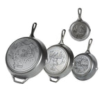 Set of four Lodge cast iron skillets with engraved designs of wildlife on the back of each skillet.