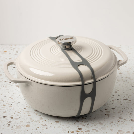 Grey lid latch being used on enamel dutch oven.