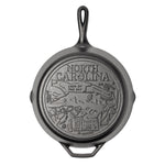 Cast iron skillet with the bottom engraved with beloved icons and monuments from North Carolina.