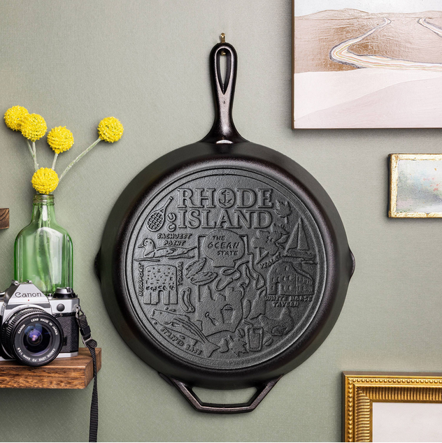 Rhode Island state skillet hung on wall to display.