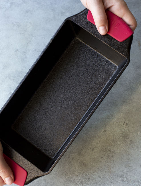 Someone holding our loaf pan using the bakeware grips.