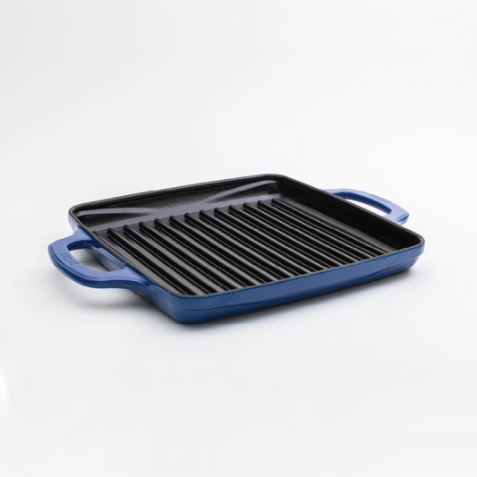 Enameled, square grill pan with a blue exterior and a black cooking surface.
