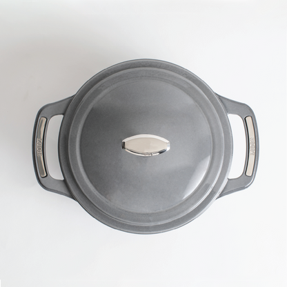 Top view of grey dutch oven featuring silver knob on lid and silver accents on handles.