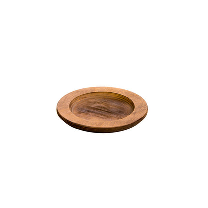 A circular wooden underliner with indent for skillet or other serving dish.