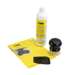 A collection of items for an enameled cast iron and stoneware care kit including a bottle of enamel cleaner, a black scrub brush with stiff bristles, a black pan scraper, and pot protectors.
