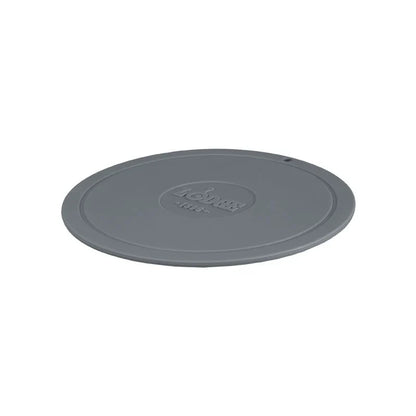 Grey circular trivet with Lodge branding in center.