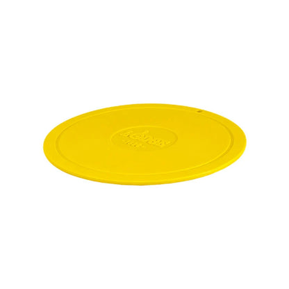 Yellow circular trivet with Lodge branding in center.