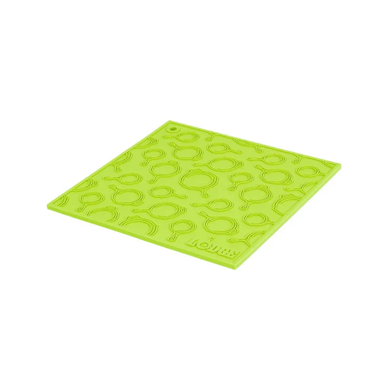 Green silicone trivet with embossed Lodge skillets scattered throughout surface.