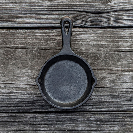 Skillet on wooden background.