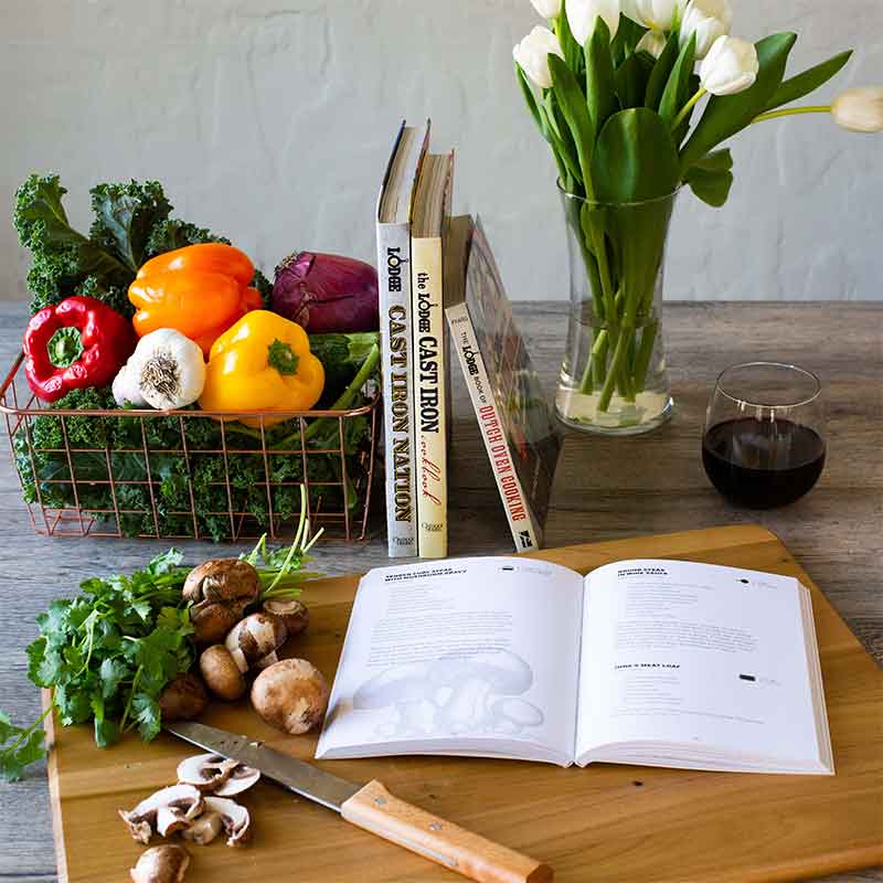Cook book open on counter with a recipe displayed near ingredients.