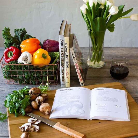 Cook book open on counter with a recipe displayed near ingredients.