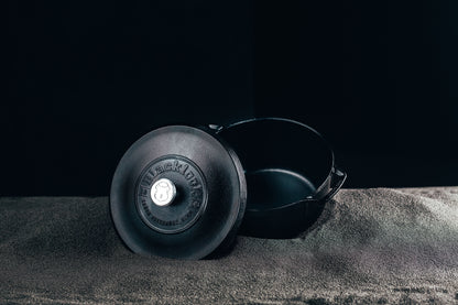Dutch oven displayed on black background.