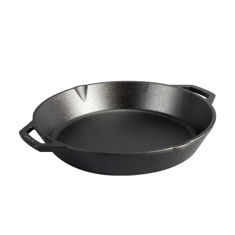 Black cast iron skillet with two loop handles and two pour spots.