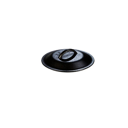 Seasoned cast iron lid with Lodge branding and handle in the middle.