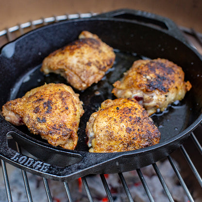 Chicken being cooked in pan.