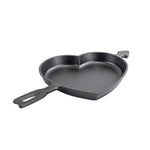 Baking pan in shape of a heart, with the handle shaped as Cupid's arrow going into it.