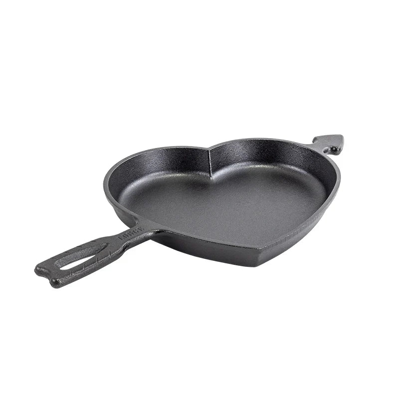 Baking pan in shape of a heart, with the handle shaped as Cupid's arrow going into it.