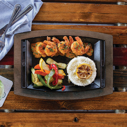 Freshly made meal served on table with griddle and underliner.