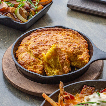 Fresh cornbread served in skillet on underliner.
