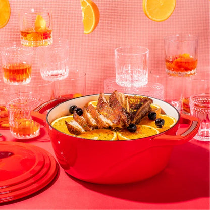 Freshly prepared old fashioned infused pork belly in front of glassed of Old Fashion's and oranges.